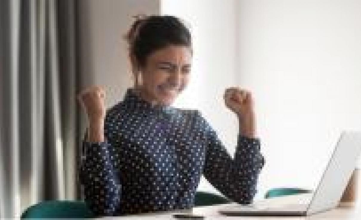 Woman winning raising hands