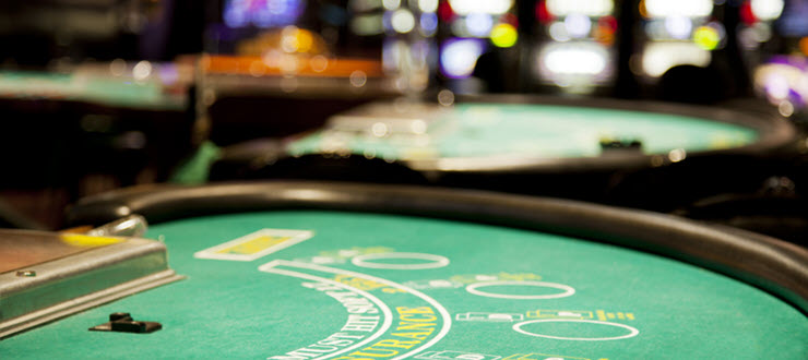 Empty Blackjack table with slots in the distance