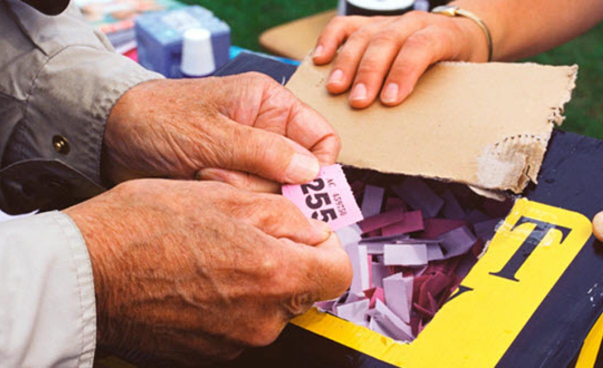 Man holding raffle tickets