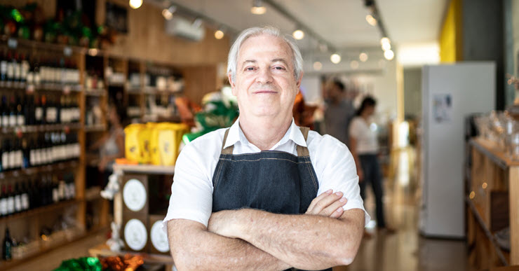 Liquor store merchant in front of his store